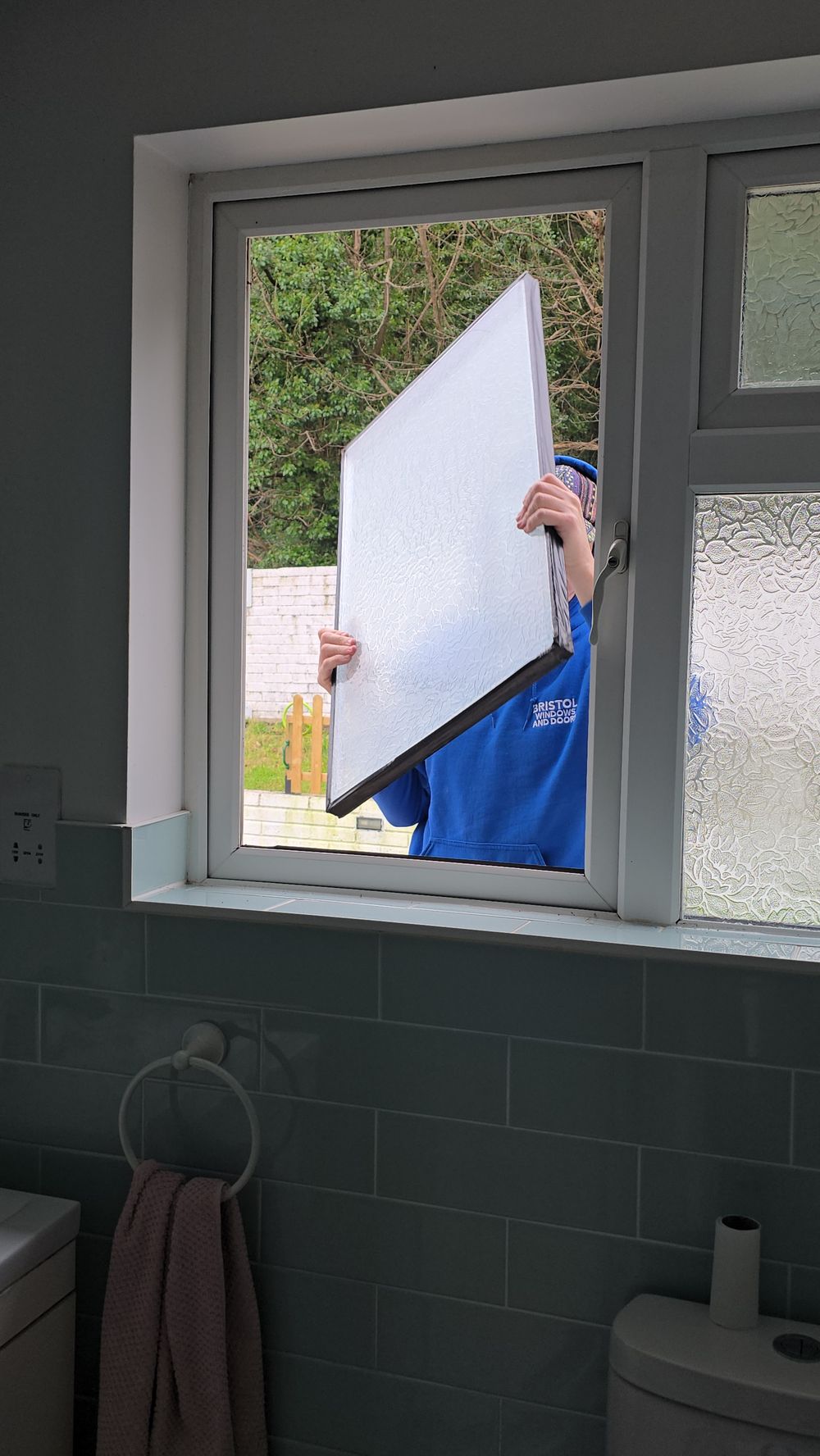 New double-glazed unit being installed in a Bristol bathroom window
